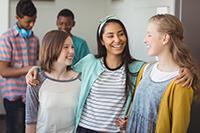 Three teenagers standing together in a group