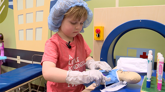 A child plays doctor with a doll