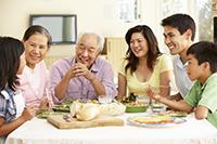 A family of six sits around a dinner table